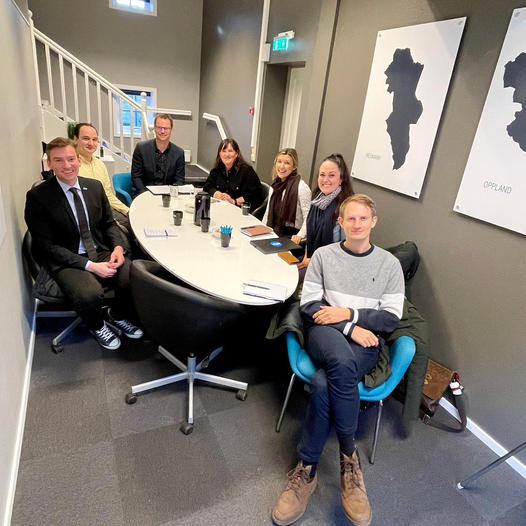 a group of people sitting around a table.