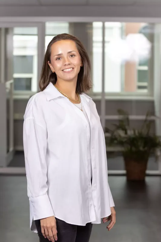 a woman in a white shirt and black pants.