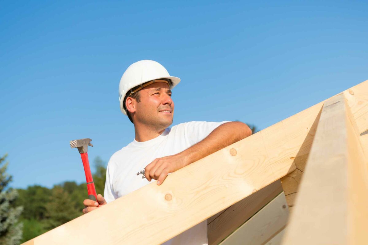 a man in a hard hat holding a hammer.