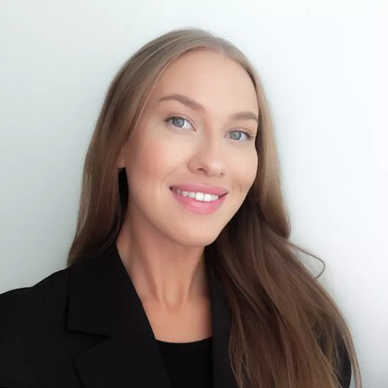 a woman with long hair wearing a black jacket.