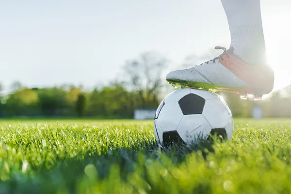 a person standing on top of a soccer ball.