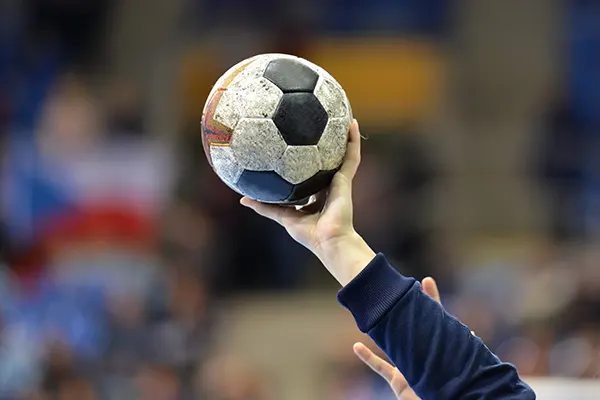 a person holding a soccer ball in their hand.