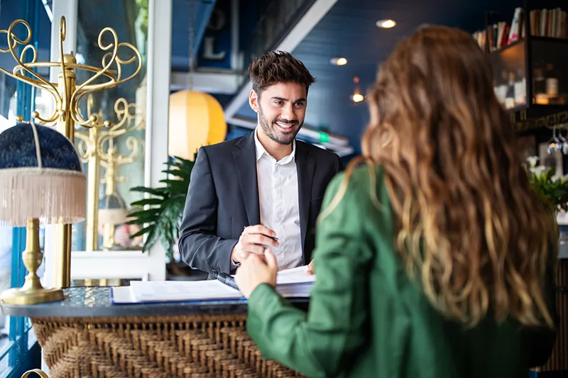 man serving woman at hotel lobby