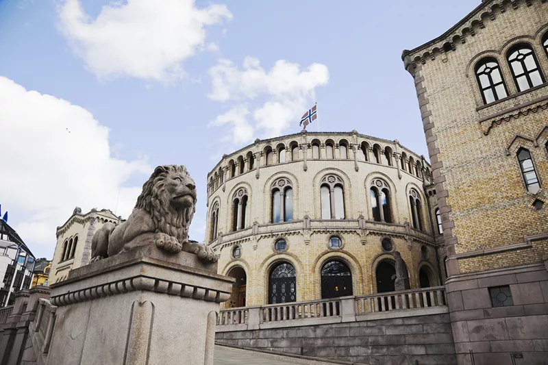 a large building with a lion statue in front of it.