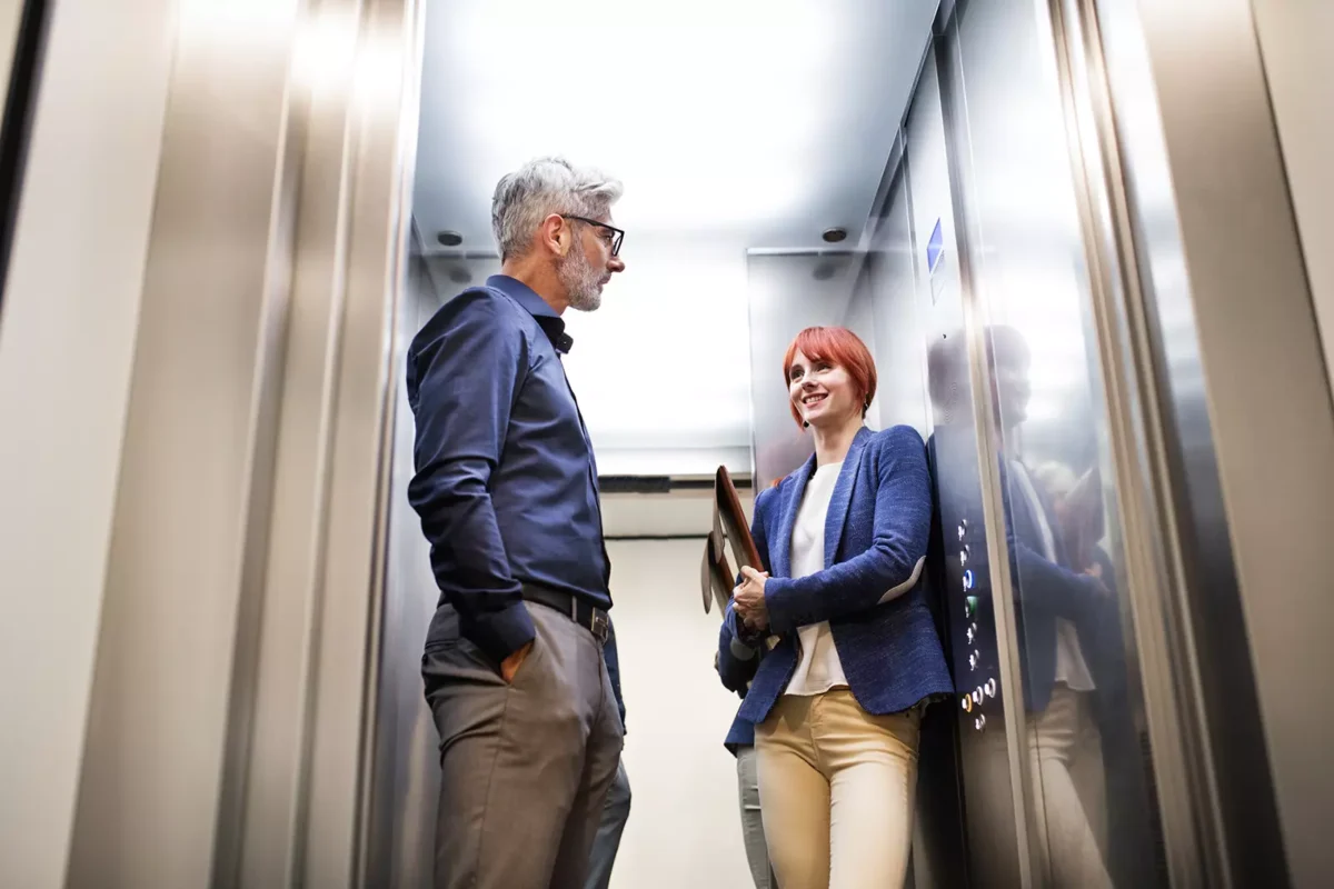 A man and a woman in an elevator.